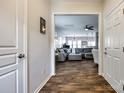 Open-concept living room with wood floors, gray sectional sofa, and modern ceiling fan at 4107 Park South Station Blvd, Charlotte, NC 28210
