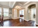 Elegant foyer with dark hardwood floors, tray ceilings, and a view into a home office space at 4220 Thames Cir, Fort Mill, SC 29715