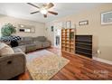 Comfortable living room featuring hardwood floors, a ceiling fan, and ample seating space at 427 E 12Th Ave, Gastonia, NC 28054