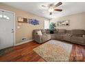 Cozy living room featuring new hardwood floors, natural light, and a large sofa at 427 E 12Th Ave, Gastonia, NC 28054