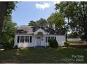 Quaint single-level home featuring dark shutters, neutral paint, and a classic roofline at 506 Linwood Rd, Gastonia, NC 28052