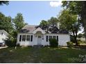 Cozy one-story home with black shutters, green grass, and a welcoming front porch at 506 Linwood Rd, Gastonia, NC 28052