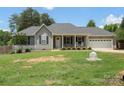 Charming single-story home featuring a covered front porch, gray siding, and a two-car garage at 7627 Sarah Dr, Denver, NC 28037