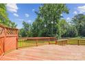 Large wooden deck with railing and lattice accents, perfect for outdoor entertaining and relaxation at 8706 Richardson King Rd, Waxhaw, NC 28173