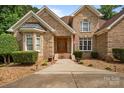 Charming brick home featuring manicured landscaping and a welcoming entrance at 8918 Beach Bluff Ct, Sherrills Ford, NC 28673