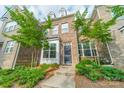 Beautiful brick townhome showcasing mature trees and manicured front yard at 11546 Red Rust Ln, Charlotte, NC 28277