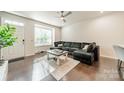 Comfortable living room features hardwood floors, a large window, and a cozy couch at 11546 Red Rust Ln, Charlotte, NC 28277