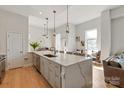 Spacious kitchen featuring an oversized island with bar seating, stainless appliances, and hardwood floors at 1315 East Blvd # 225, Charlotte, NC 28203