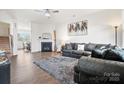 Bright living room featuring a fireplace, open floor plan, and comfortable seating at 1343 Kent Downs Sw Ave, Concord, NC 28027