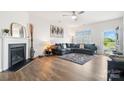 Cozy living room featuring a fireplace, stylish decor, and wood flooring at 1343 Kent Downs Sw Ave, Concord, NC 28027