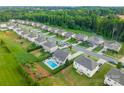 Aerial view of a neighborhood with mature trees, manicured lawns, and a pool in a private backyard at 163 Sassafras Rd, Mooresville, NC 28115