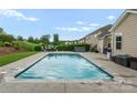 Beautiful in-ground pool with a patio, perfect for outdoor entertaining and relaxing in the backyard oasis at 163 Sassafras Rd, Mooresville, NC 28115
