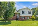 Classic home with a brick and siding exterior, complemented by a well-maintained front yard and mature tree at 2000 Townsend Ave, Charlotte, NC 28205