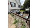 A cluttered paved driveway leading to attached garages at 2056 Evergreen Dr, Newton, NC 28658