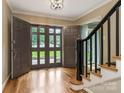 Bright foyer with wooden floors, black banister, and stylish double doors at 2141 Halford Pl, Charlotte, NC 28211