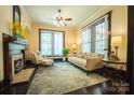 The living room showcases neutral walls, a ceiling fan, and two large windows at 215 W Eastway Drive Dr, Charlotte, NC 28213