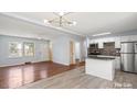 Open-concept living space featuring hardwood floors that blend seamlessly with a modern kitchen and bright lighting at 2515 Danforth Ln, Charlotte, NC 28208