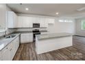 Modern kitchen features granite countertops, stainless steel appliances, and a spacious island, perfect for cooking and entertaining at 2591 Watson Dr, Lancaster, SC 29720