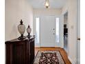 Inviting foyer with hardwood floors, decorative rug, and elegant lighting at 2620 Yarrow Rd, Charlotte, NC 28213