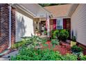 Charming front porch with colorful flowers, brick accents, and an American flag at 2620 Yarrow Rd, Charlotte, NC 28213
