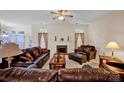 Spacious living room with plush leather furniture, fireplace, and natural light at 2620 Yarrow Rd, Charlotte, NC 28213