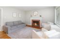 Cozy living room featuring a brick fireplace, hardwood floors and stylish decor at 3969 Sheffield Dr, Charlotte, NC 28205