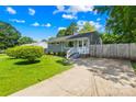 Traditional home featuring a long driveway, green lawn, and partially fenced yard at 411 Belvedere Cir, Kings Mountain, NC 28086