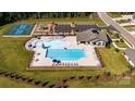 Aerial view of a community pool with tennis courts, playground, and ample parking at 440 Court House Ave, York, SC 29745