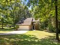 Charming brick home featuring a two-car garage and lush green lawn at 4444 Steepleton Way, Charlotte, NC 28215