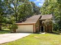 Charming brick home featuring a two-car garage and lush green lawn at 4444 Steepleton Way, Charlotte, NC 28215