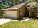 Inviting front entrance of a brick home with a two-car garage at 4444 Steepleton Way, Charlotte, NC 28215