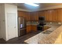 Updated kitchen with stainless steel appliances, granite countertops, and wooden cabinets at 4454 Glenlea Commons Dr, Charlotte, NC 28216