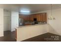 Open kitchen featuring stainless steel appliances and a breakfast bar overlooking the dining area at 4454 Glenlea Commons Dr, Charlotte, NC 28216