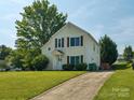 Inviting two-story home with a well-manicured lawn and mature tree providing shade at 5701 Silver Eagle Dr, Charlotte, NC 28214