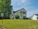 Inviting two-story home with a well-manicured lawn and mature tree providing shade at 5701 Silver Eagle Dr, Charlotte, NC 28214