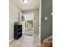 Bright foyer featuring tile flooring and a view of the outdoors through the front door at 5701 Silver Eagle Dr, Charlotte, NC 28214