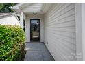 Welcoming front entrance with a stylish black door and lush green shrubbery at 5717 Fairchase Ave, Charlotte, NC 28269