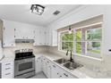 Bright kitchen with white cabinetry, marble countertops, stainless steel appliances, and a view from the window at 10016 Heathergate Ln, Mint Hill, NC 28227