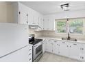 Bright kitchen with white cabinets, stainless steel oven, and a white refrigerator for a clean aesthetic at 10016 Heathergate Ln, Mint Hill, NC 28227