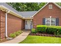 Close up of a home's front entrance with beautiful brickwork and landscaped shrubbery at 103 Prestwick Ct, Salisbury, NC 28146