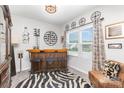 Bright living room boasts a bar area, a window with blinds, decorative wall art and a zebra print rug at 1117 Laurel Woods Dr, Gastonia, NC 28052