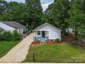 Charming home with a landscaped front yard and a gravel driveway at 1210 Cloninger Ave, Gastonia, NC 28052
