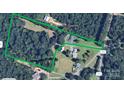 Aerial view of a large property with a home, surrounded by lush greenery and mature trees at 12143 Asbury Chapel Rd, Huntersville, NC 28078