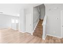 Hallway featuring a staircase, fresh paint, wood-look flooring, and neutral tones at 12452 Stratfield Place Cir, Pineville, NC 28134