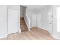Bright entryway featuring a staircase, fresh paint, wood-look flooring, and neutral tones at 12452 Stratfield Place Cir, Pineville, NC 28134