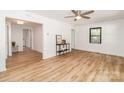 Bright living room with hardwood floors, white trim, and natural light; features a ceiling fan at 13414 Central Ave, Huntersville, NC 28078