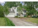 Beautiful exterior view of a two-story home with an attached garage and a long driveway at 13416 Kintyre Ct, Matthews, NC 28105