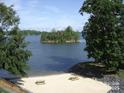 Private beach featuring benches, picnic tables and scenic views of an island on the beautiful lake at 14529 Waterside Dr, Charlotte, NC 28278
