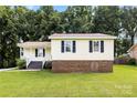 Ranch home with a well-manicured lawn and dark shutters at 1617 Mulberry Cir, Rock Hill, SC 29732
