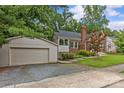 Brick home with detached garage, showcasing the driveway, landscaping, and architectural style at 2005 Scott Ave, Charlotte, NC 28203